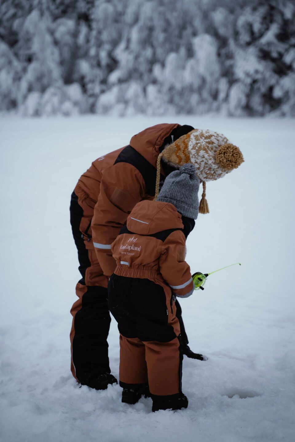 StayLapland Ice Fishing With Reindeer tour guests fishing