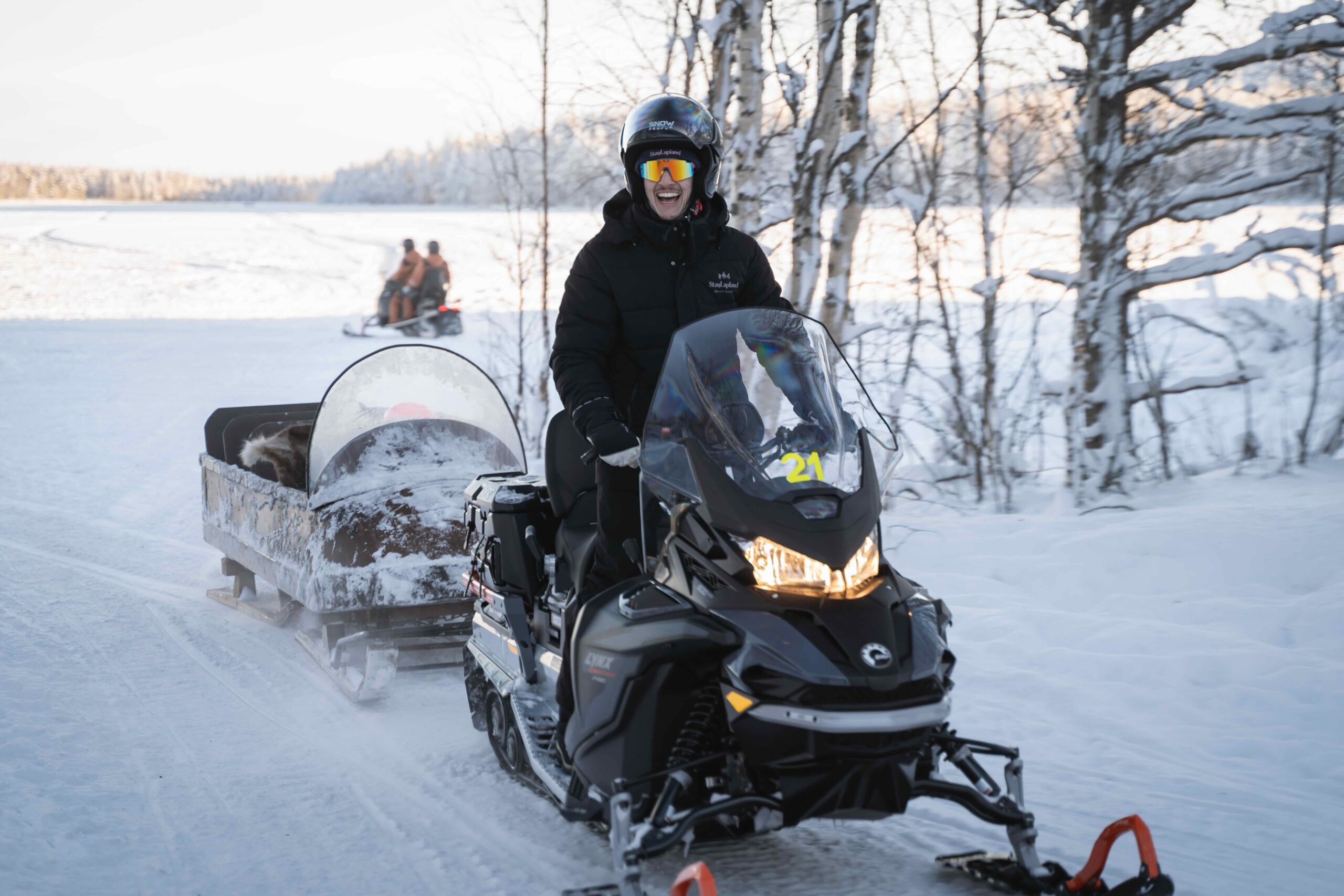 StayLapland guide driving snowmobile in Rovaniemi, Lapland, Finland
